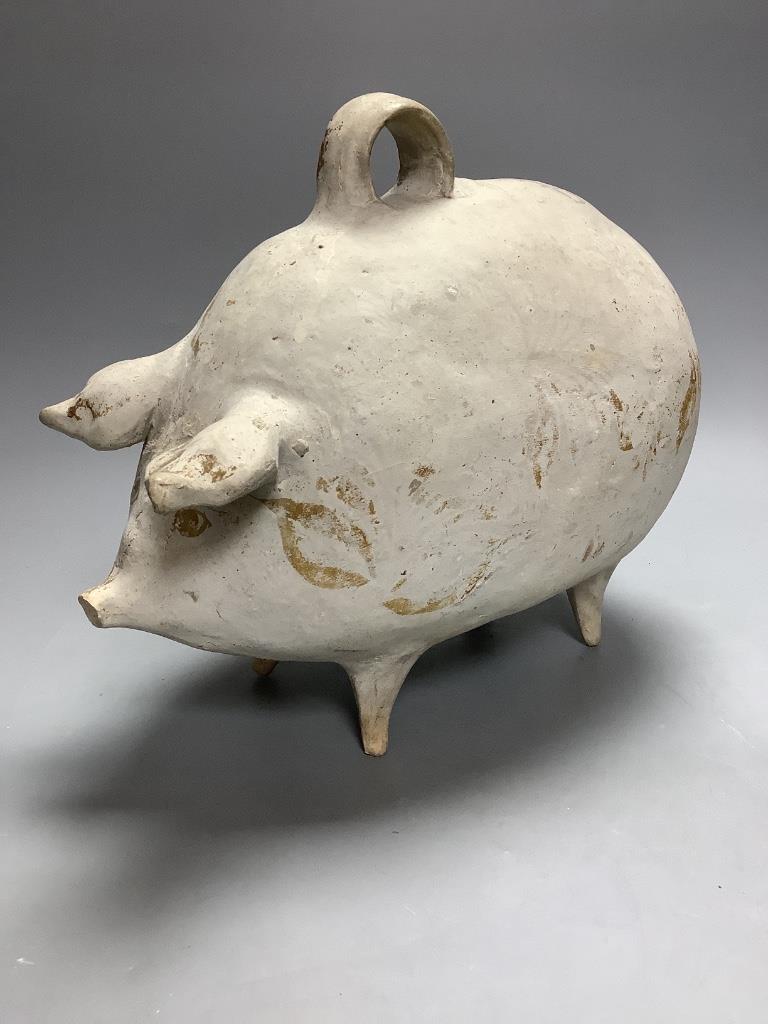 A French earthenware piggy bank, containing coins